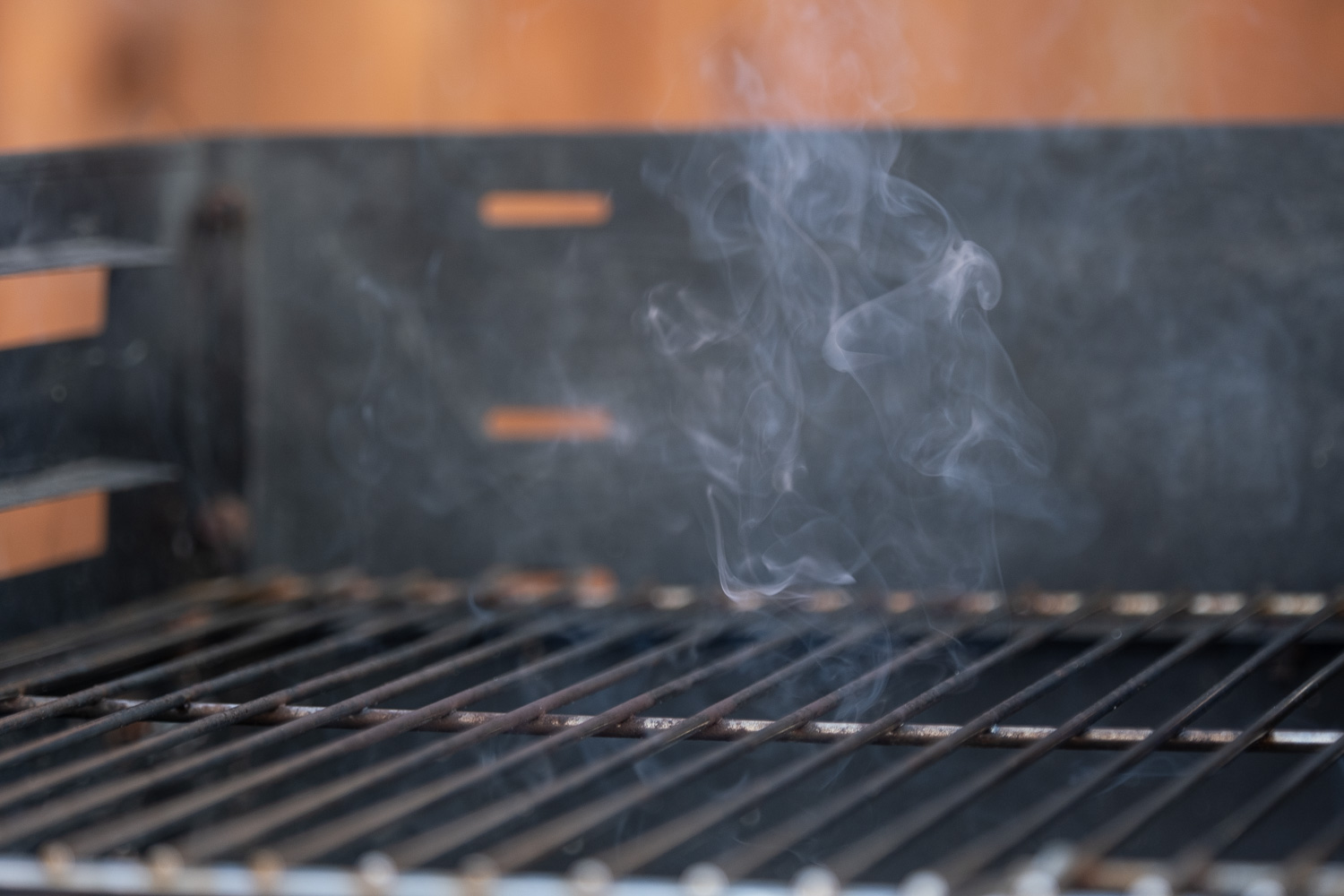First barbecue of the year. Photograph of smoke emerging from a barbecue.