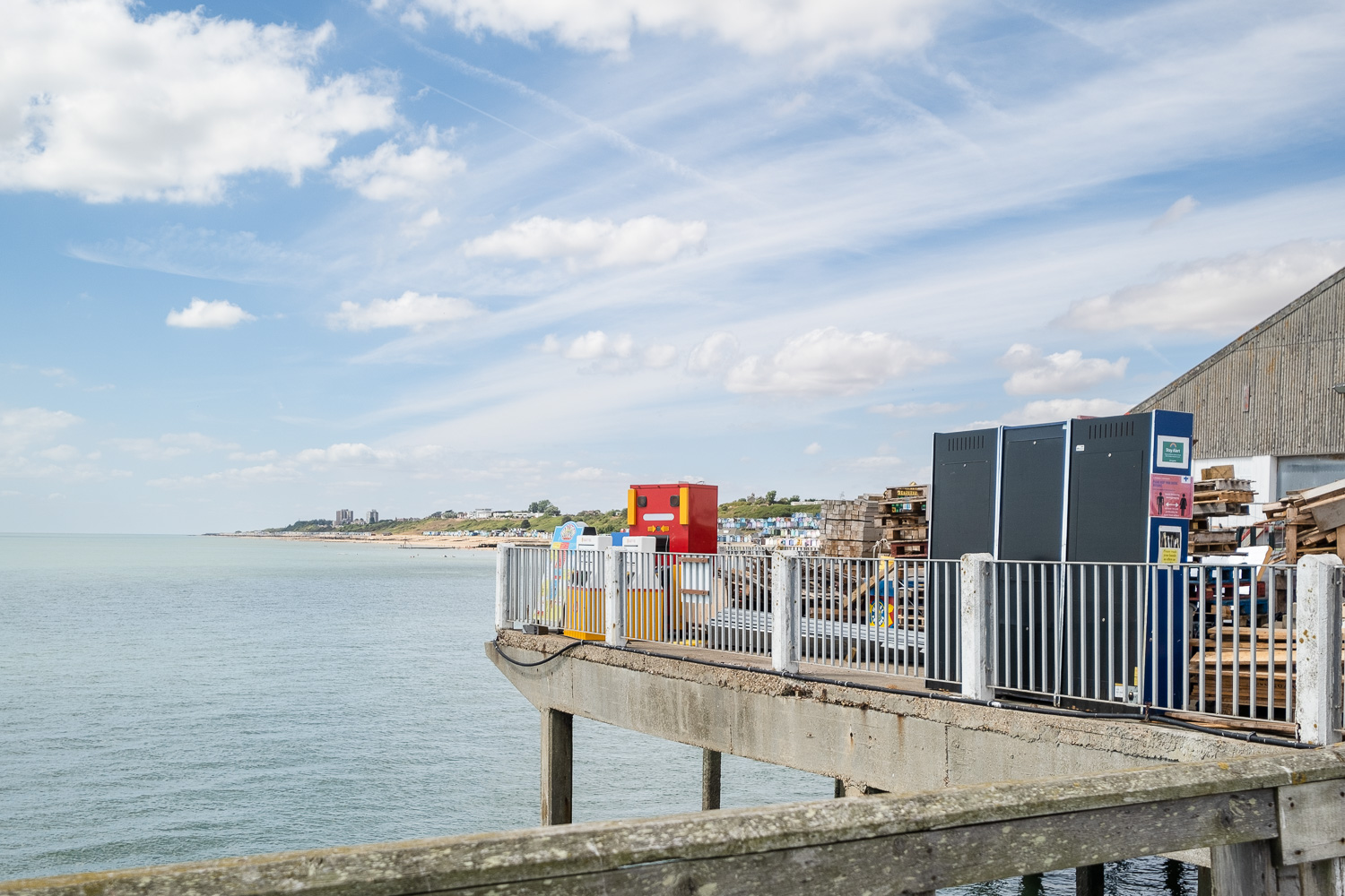Retired arcade games overlooking the sea at Walton-on-the-Naze Pier, Essex. One of the machines resembles a face looking out.