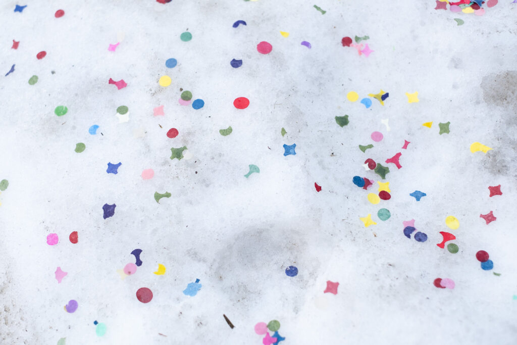 Photograph of colourful confetti on snow. Sankt Niklaus, Switzerland