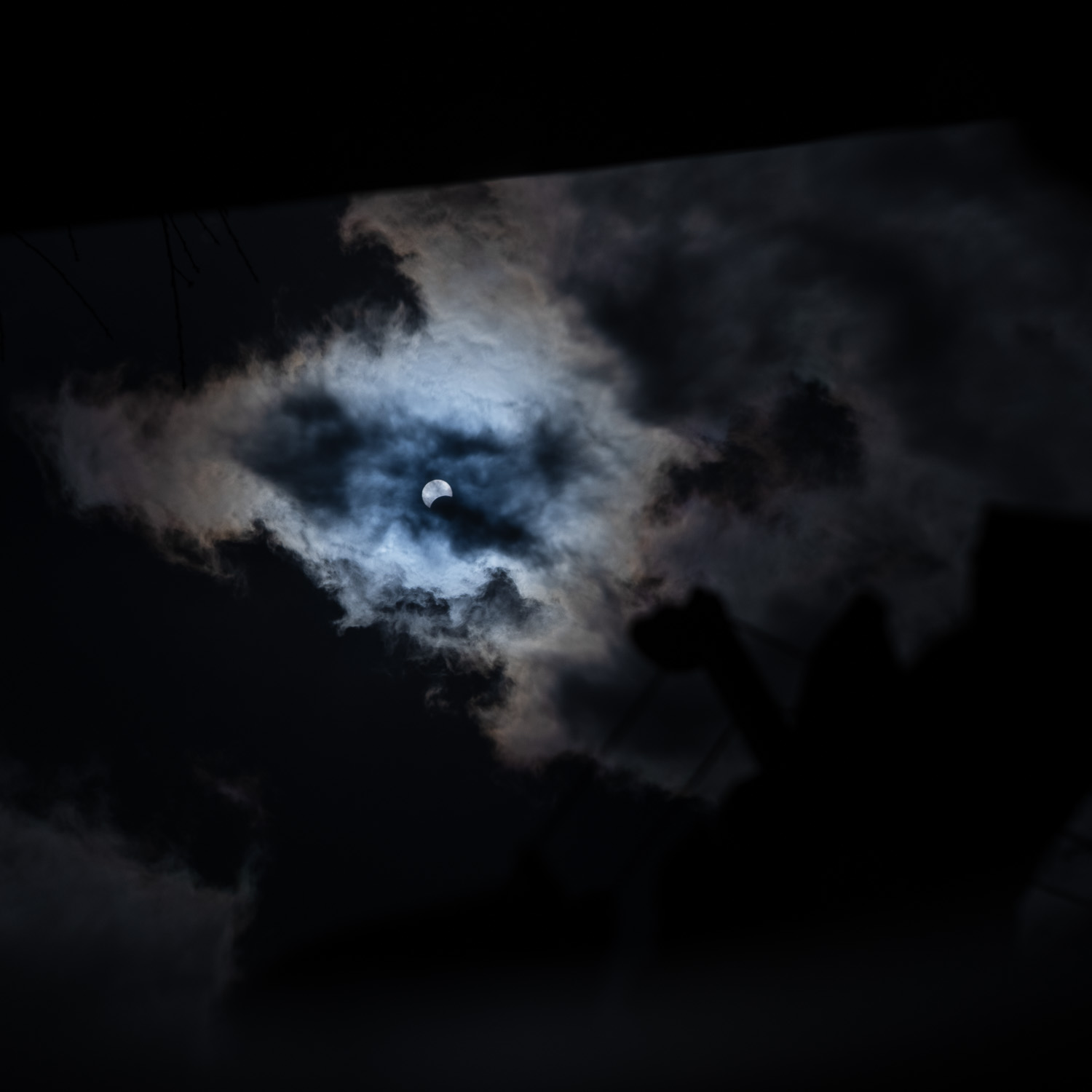 Partial Solar Eclipse reflected in a bucket of water